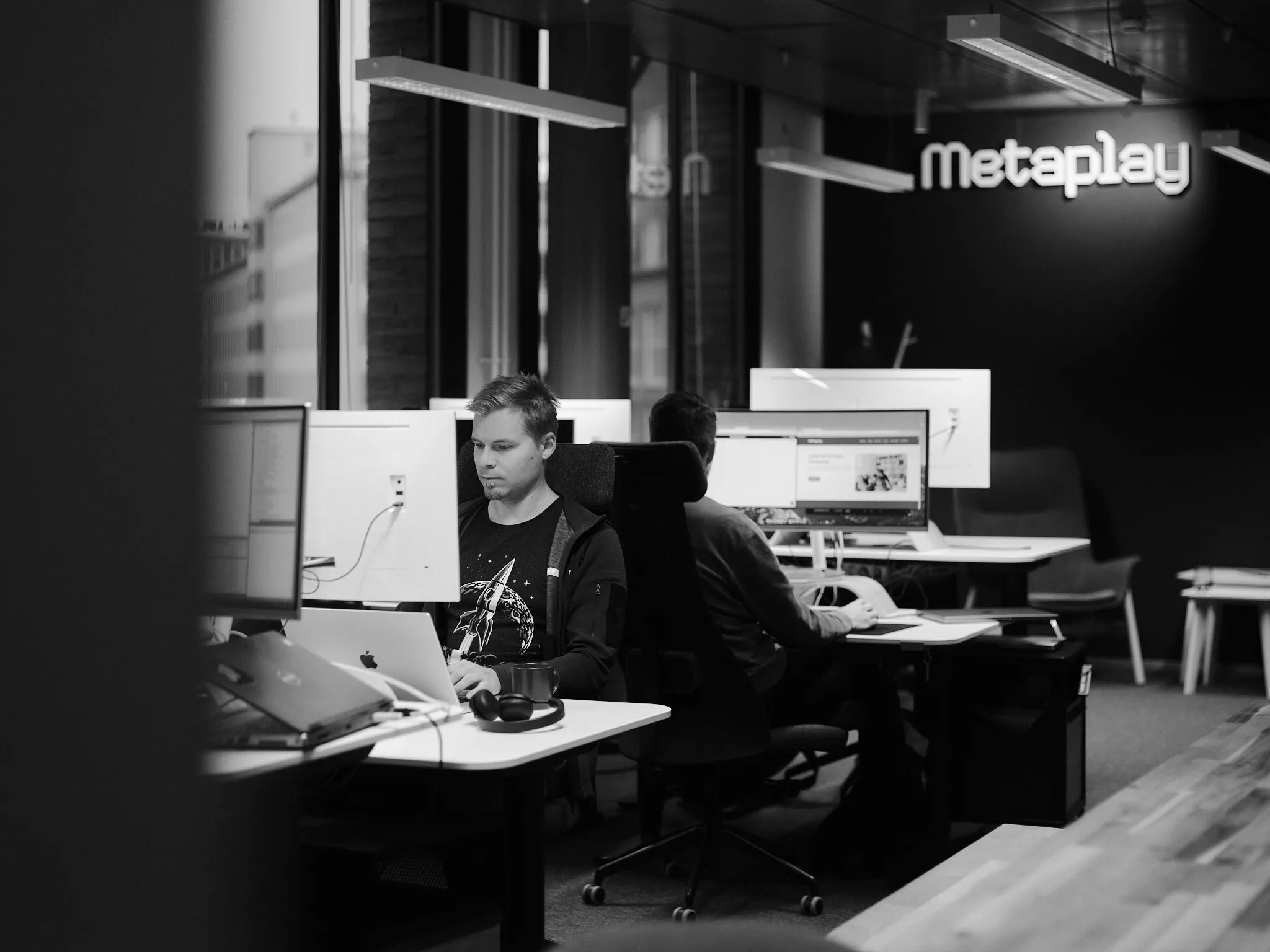 The Metaplay office with the logo on the wall